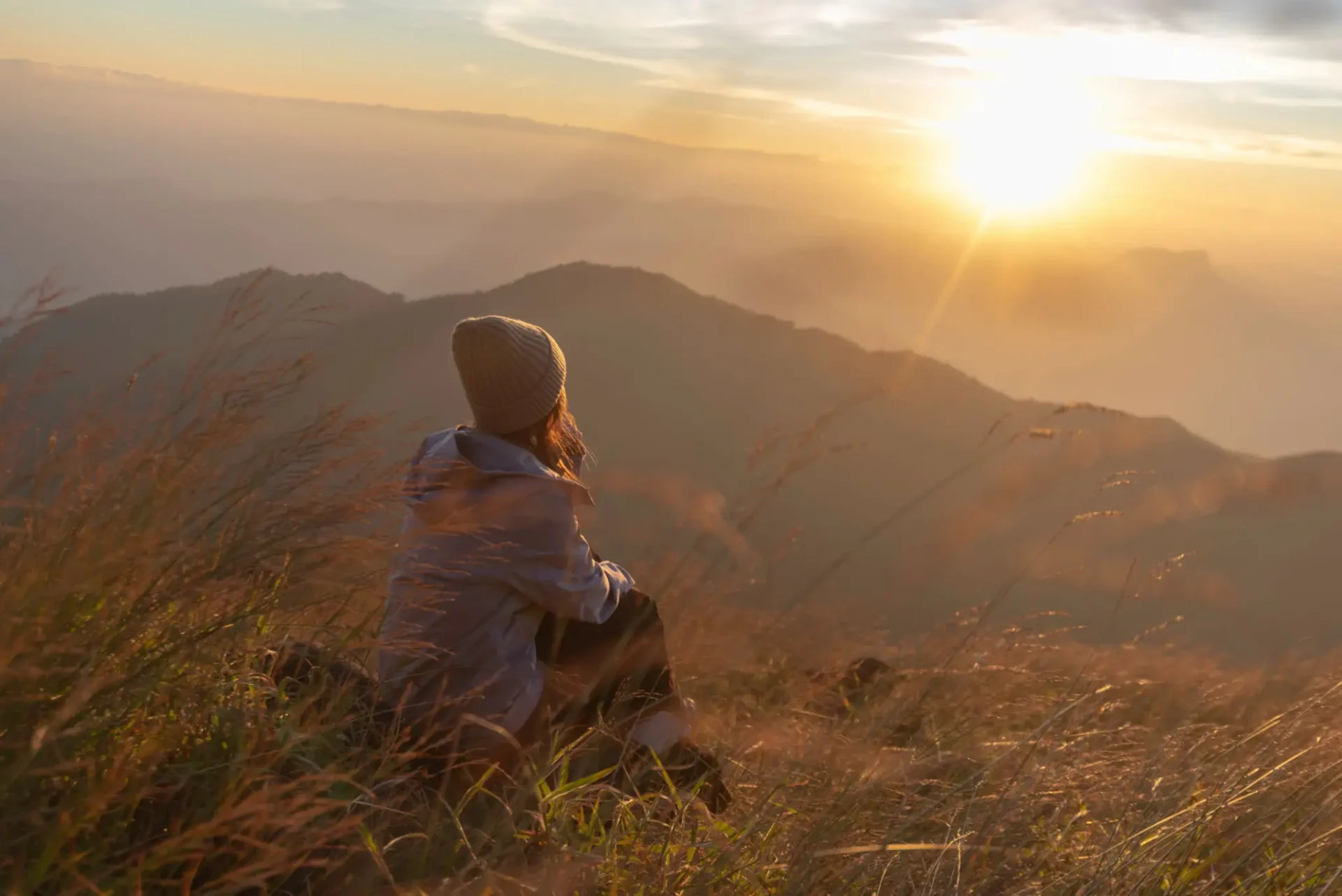 A person sitting and watching the sunset